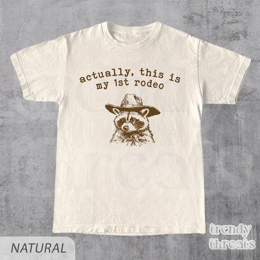 Actually, This Is My First Rodeo T-Shirt | Funny Western Graphic Tee | Raccoon Quote | Retro Shirt Unique Gift Idea | Unisex Shirt
