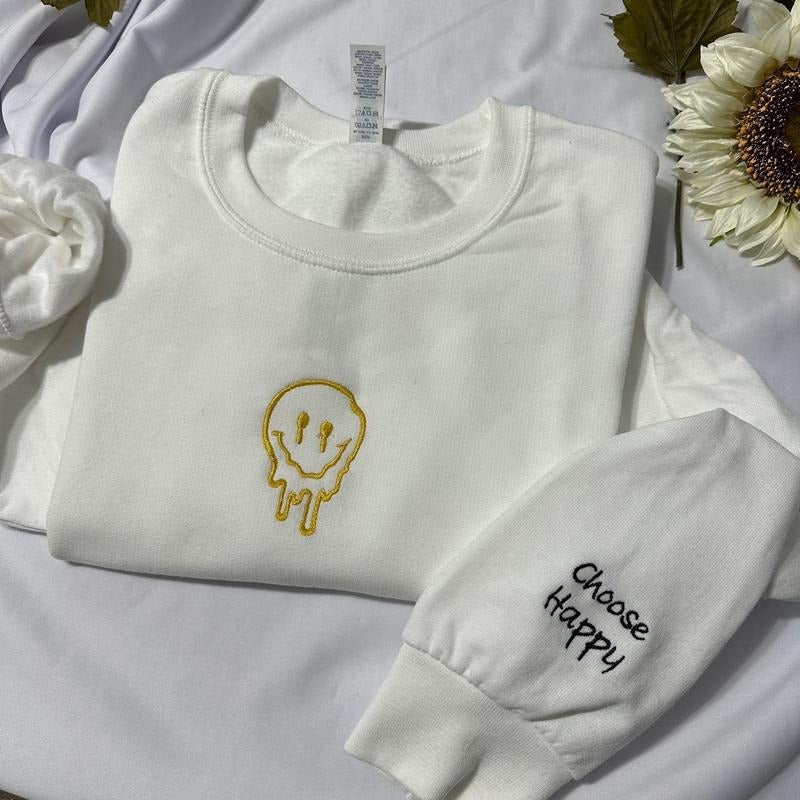 Smiley Face with Choose Happy embroidered on the cuff of the sleeve embroidered crewneck